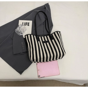 Detailed view of large black and white striped canvas tote bag showing interior capacity
