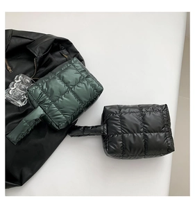 Close-up of quilted puff tote bags in black and dark green with glossy finish texture