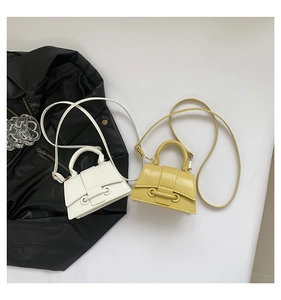 Flat lay of mini trapezoid handbags in white and yellow with smooth leather and ring buckle