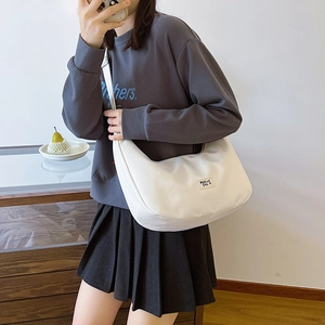 Minimalist beige nylon crescent dumpling bag with MaLui Dsi label and wide shoulder strap
