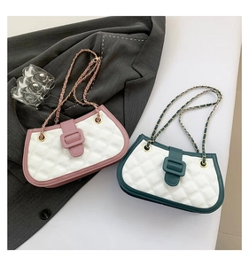 Detailed close-up of rhombus quilted small square bags with metal chain straps