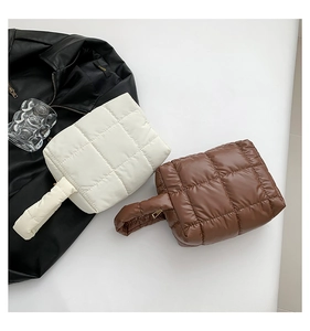Detailed top view of puffy quilted tote bags in white and brown with glossy finish