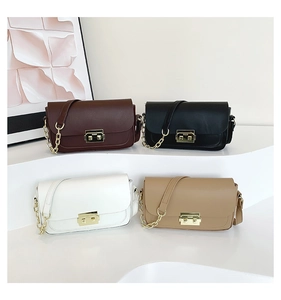 Detail showing classic small square bags in four colors with gold metal clasps and chain straps
