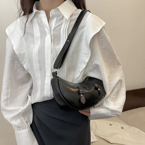 Minimalist black crescent hobo bag in glossy oil wax leather with wide shoulder strap