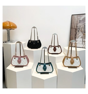 Detail showing a row of quilted chain handbags in five trendy colors on display