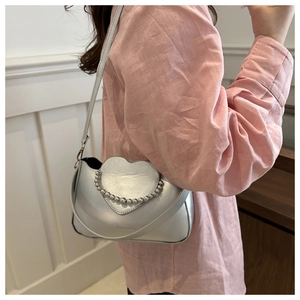Silver heart-shaped crossbody bag featuring metallic finish and bead chain detail