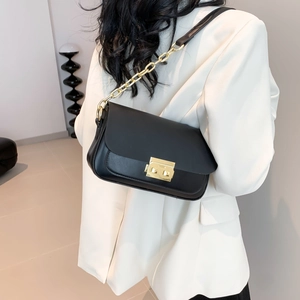 French retro black leather shoulder bag with gold square clasp and chain strap on model