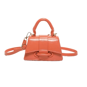 Chic coral orange trapezoid handbag with structured handle and adjustable strap