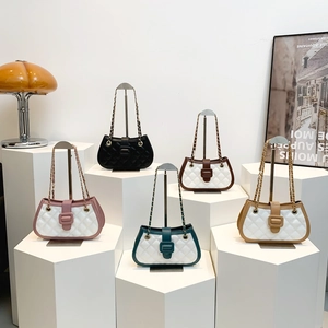 Quilted crossbody chain bags in assorted colors displayed on white geometric stands