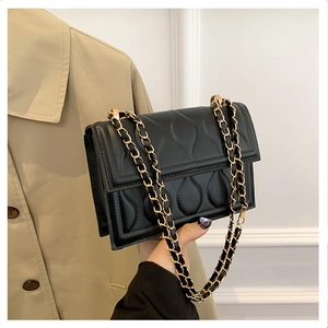 Détail du sac matelassé noir avec motifs gouttes d'eau et bandoulière chaîne dorée