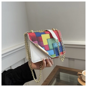 Detail of color-block flap bag with geometric patterns and gold chain strap