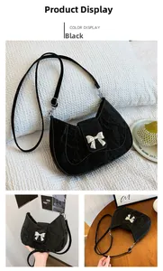 Detail of black pleated shoulder bag featuring a prominent silver metal bow hardware