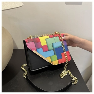 Detail of color-block flap bag with geometric patterns and gold chain strap