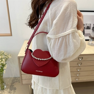 Red heart-shaped crossbody bag with silver bead trim and wide shoulder strap