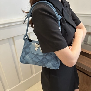 Blue denim quilted shoulder bag with silver bow hardware and knotted strap for women