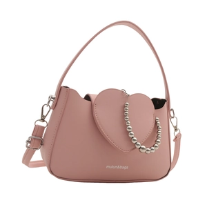 Pink heart-shaped crossbody bag with decorative silver beads and adjustable strap