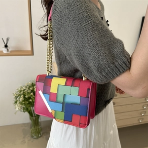 Pink PU leather crossbody bag with geometric patterns and golden chain strap