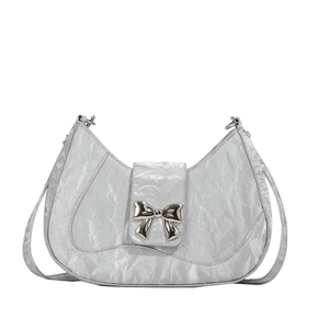 Silver crescent shoulder bag with metallic bow detail and trendy pleated texture