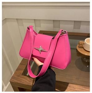 Close-up of rose pink PU leather underarm bag with silver star-shaped metal buckle detail