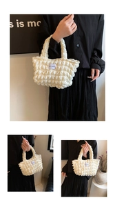 Detail of off-white popcorn texture tote bag with LOVE FASHION label and soft puffy fabric