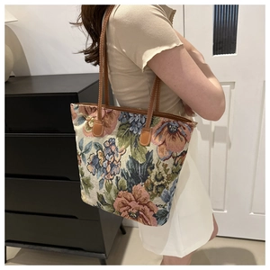 Close-up of vintage floral jacquard fabric and reinforced brown leather shoulder strap
