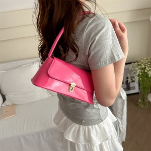 Bright pink glossy patent leather baguette shoulder bag with gold metal buckle