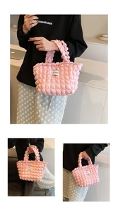 Close-up of pink bubble textured tote bag with Love Fashion label and pleated fabric