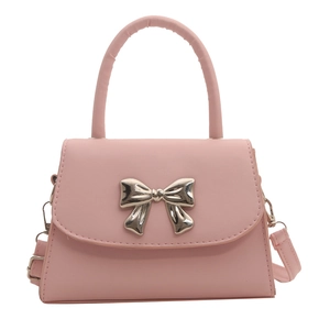 Pink crossbody handbag with metal bow accent and top handle for elegant summer styling