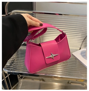 Detail of magenta PU leather shoulder bag featuring silver metal star buckle and fine stitching