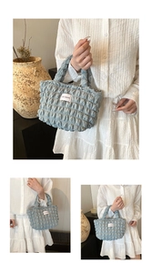 Detail of light blue bubble textured fabric and fashion label on puffy tote bag