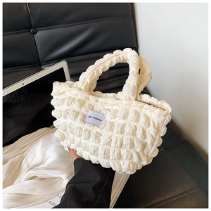 Close-up of white bubble cloud handbag with LOVE FASHION label and textured handle