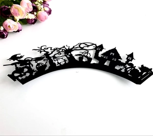 Macro view of laser cut Halloween cupcake wrappers featuring spooky castle and moon silhouettes