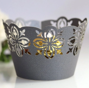 Macro detail of laser-cut wedding cake wrapper featuring grey lace floral patterns