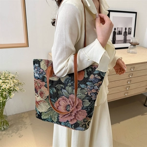 Ethnic style floral jacquard tote bag with pink roses and leather straps on white background
