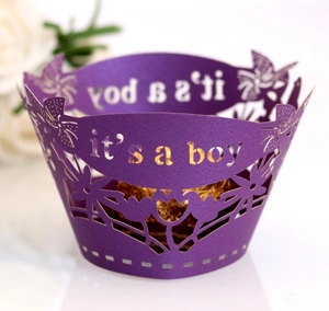 Laser cut purple cupcake wrappers with It's a Boy text for baby shower decorations