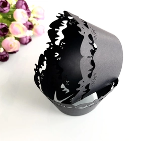 Detailed view of black laser-cut hollow pattern cupcake wrappers for Halloween decoration