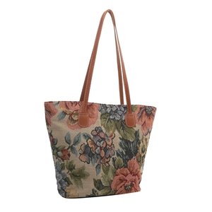 Ethnic vintage floral tapestry tote bag with brown leather handles on white background