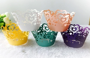 Close-up of laser-cut heart pattern cupcake wrappers in five vibrant colors