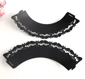 Detailed laser-cut black paper cupcake liners with a spooky bat motif for Halloween