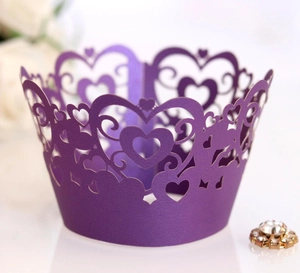 Detail of laser-cut heart pattern on deep purple cupcake wrapper with rhinestone