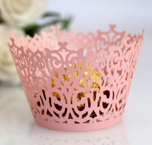 Detailed laser-cut pink cupcake wrapper with elegant floral patterns for wedding decor