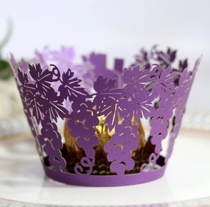 Purple laser-cut grapevine cupcake wrapper with intricate hollow vine patterns