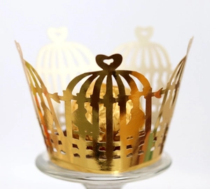 Golden laser-cut cupcake wrappers with birdcage and heart design for dessert decoration