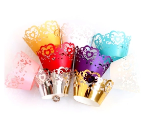 Elegant laser-cut heart cupcake wrappers in various pearlescent colors for wedding decor