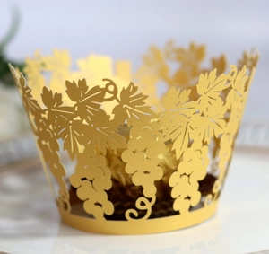 Laser-cut gold cupcake liners featuring intricate vine and leaf patterns for baking