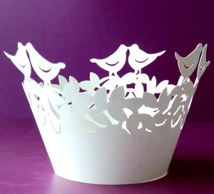 Detailed laser-cut white cupcake wrapper featuring romantic bird and leaf hollow patterns