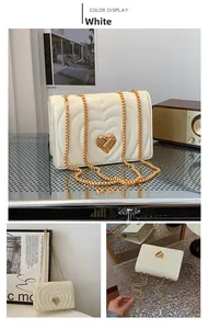 Detail of white quilted heart stitching texture with gold heart-shaped metal lock and chain