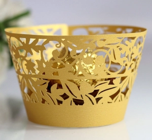 Golden laser-cut leaf pattern cupcake wrappers with elegant pearlescent finish for weddings