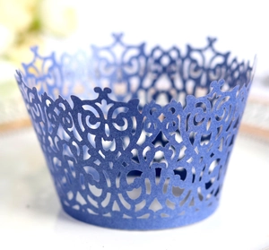 Detailed laser-cut crown pattern on dark blue pearlescent cupcake wrappers for weddings