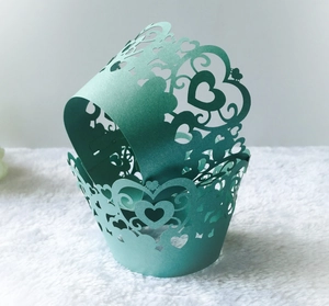 Mint green laser cut cupcake wrappers with heart patterns for wedding party decor